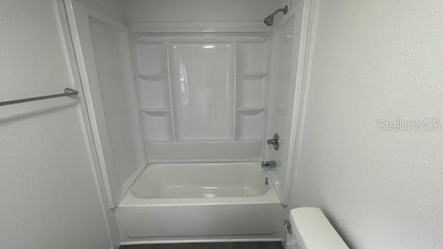 8897 Southwest 34th Court Ocala, FL 34476 - Photo 14 of 18 a bathroom with a bathtub