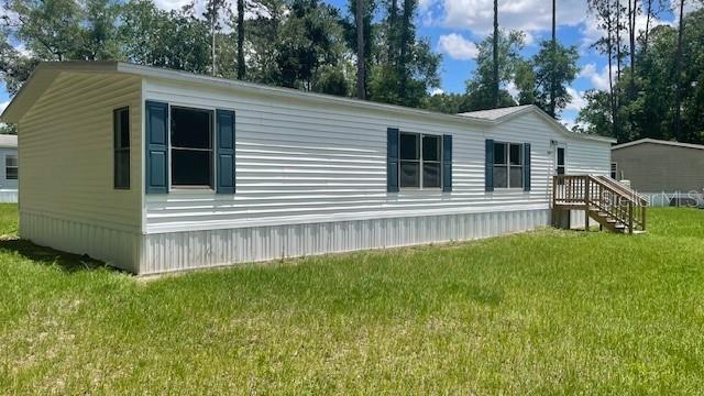 8897 Southwest 34th Court Ocala, FL 34476 - Photo 2 of 18 a view of a house with a backyard