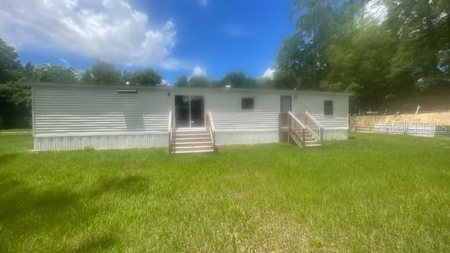 8897 Southwest 34th Court Ocala, FL 34476 - Photo 3 of 18 a view of a house with a yard