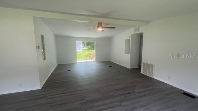 8897 Southwest 34th Court Ocala, FL 34476 - Photo 6 of 18 an empty room with wooden floor and windows