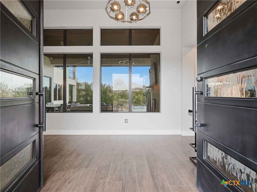 5913 Verden Ridge New Braunfels, TX 78132 - Photo 3 of 48 a view of an empty room with a window and wooden floor