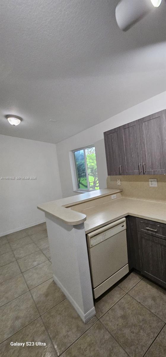 935 Northeast 33rd Terrace, Unit 204 Homestead, FL 33033 - Photo 15 of 28 a kitchen with granite countertop a sink and a stove