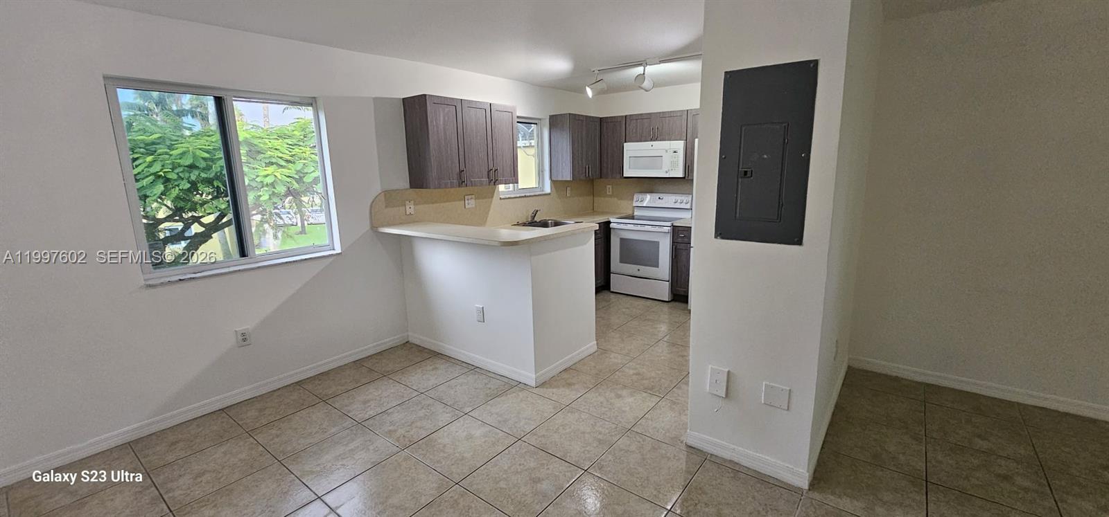 935 Northeast 33rd Terrace, Unit 204 Homestead, FL 33033 - Photo 16 of 28 a kitchen with a refrigerator and window