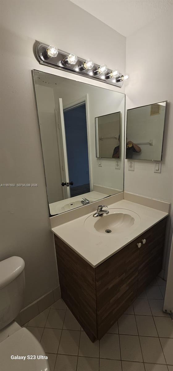 935 Northeast 33rd Terrace, Unit 204 Homestead, FL 33033 - Photo 17 of 28 a bathroom with a sink toilet and mirror