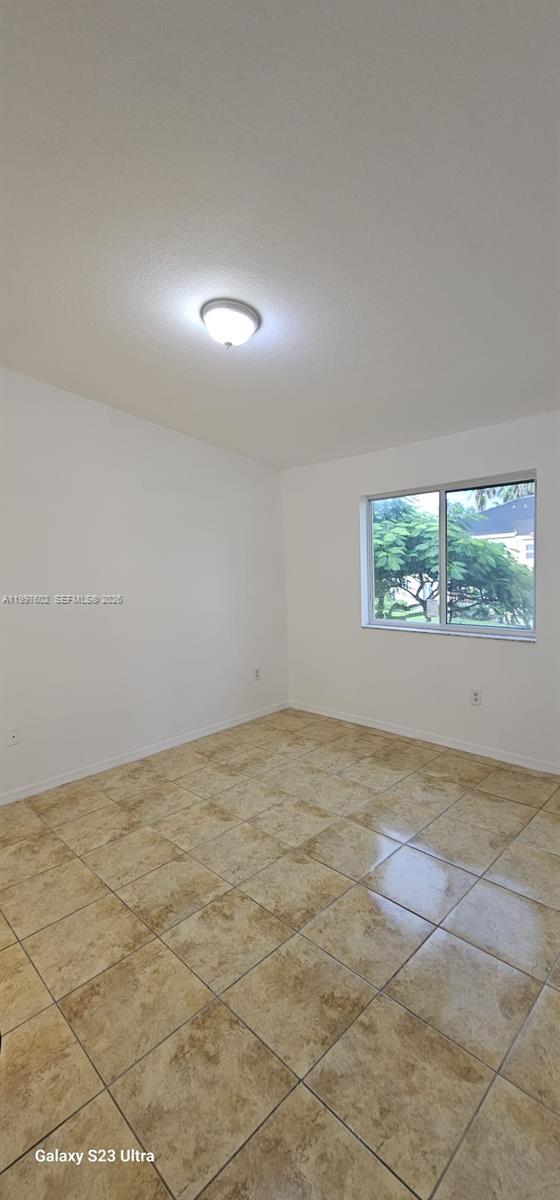 935 Northeast 33rd Terrace, Unit 204 Homestead, FL 33033 - Photo 18 of 28 a view of an empty room and a window