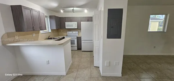 a kitchen with stainless steel appliances granite countertop a refrigerator sink and stove