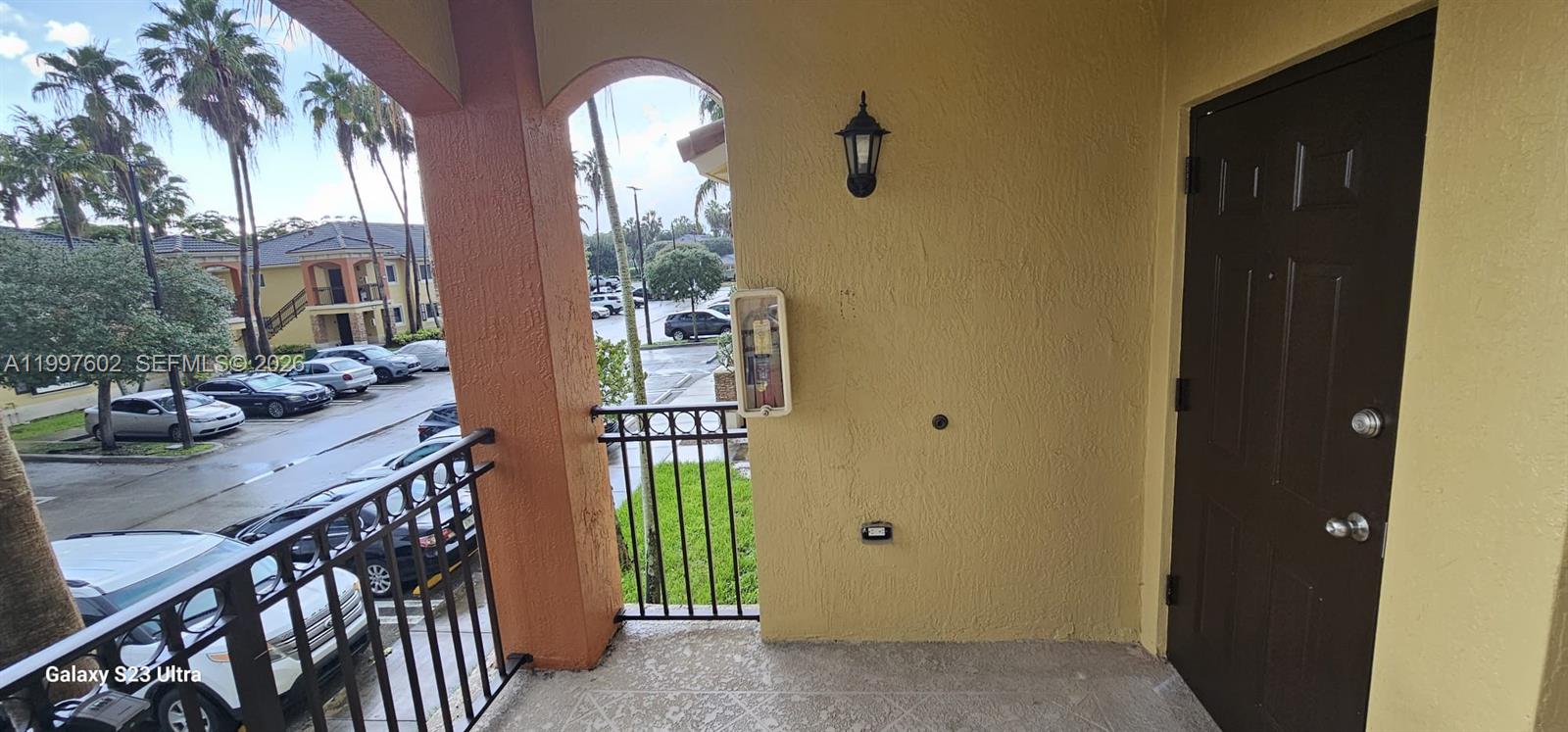 935 Northeast 33rd Terrace, Unit 204 Homestead, FL 33033 - Photo 8 of 28 a view of balcony with outdoor seating and stairs