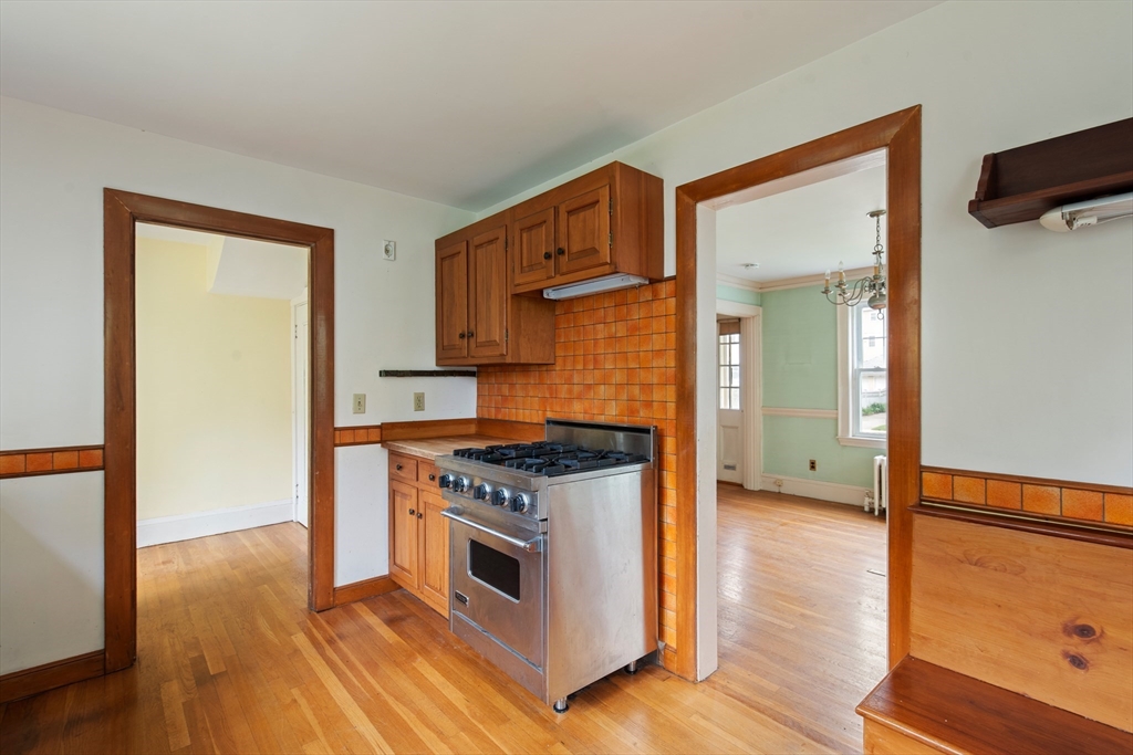 38 Bailey Road Arlington, MA 02476 - Photo 10 of 30 a kitchen with a stove and a wooden floor