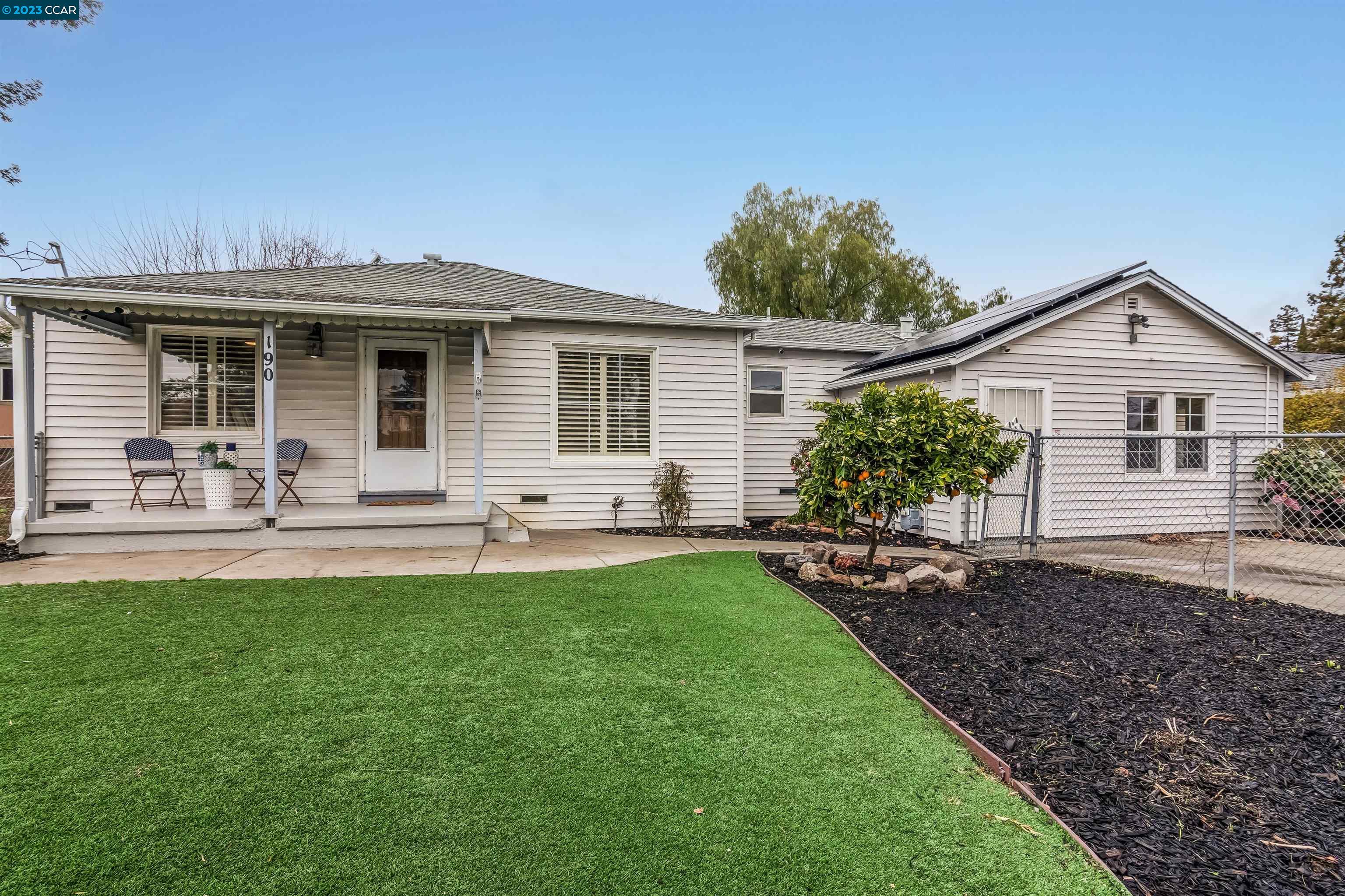 a front view of house with yard and outdoor seating