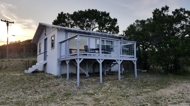 a view of a house with a yard and sitting area