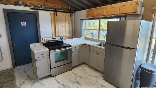 a kitchen with a refrigerator and a window