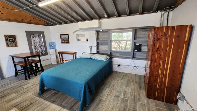 a spacious bedroom with a bed a table and chair