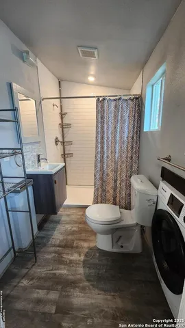 a white toilet sitting next to a bathroom sink and tub