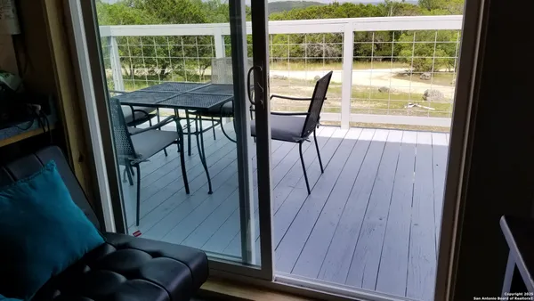 a view of a room with wooden floor and furniture