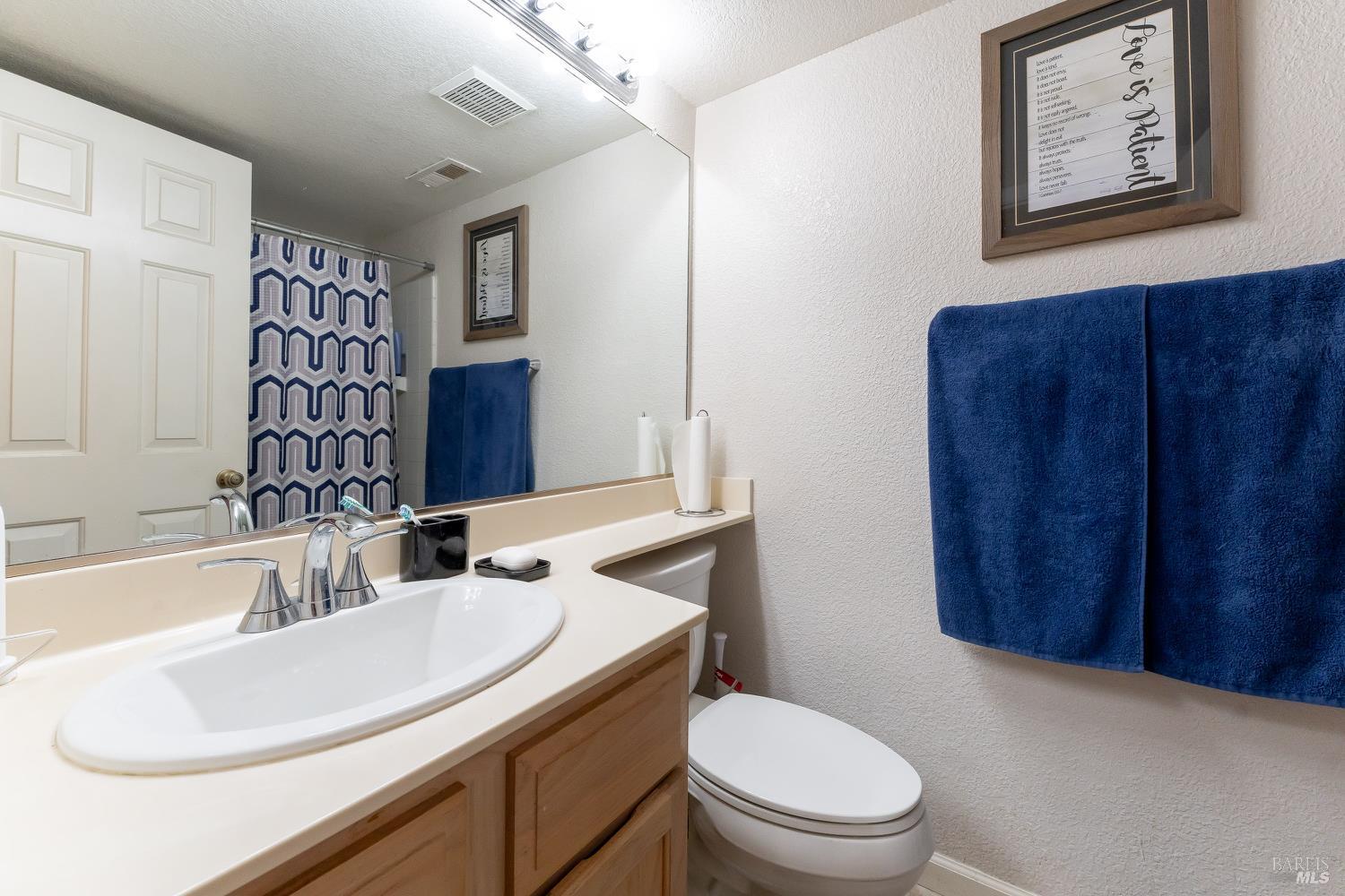 911 Point Reyes Court, Unit 6 Vallejo, CA 94591 - Photo 16 of 35 a bathroom with a toilet sink and mirror