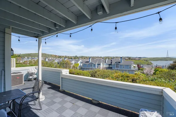 a view of a balcony with wooden benches