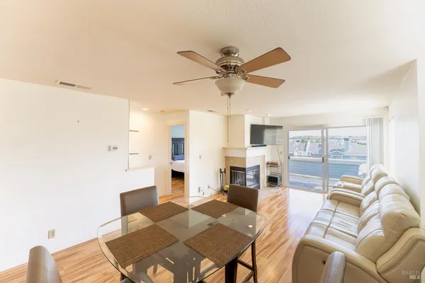 a living room with furniture and a view of kitchen