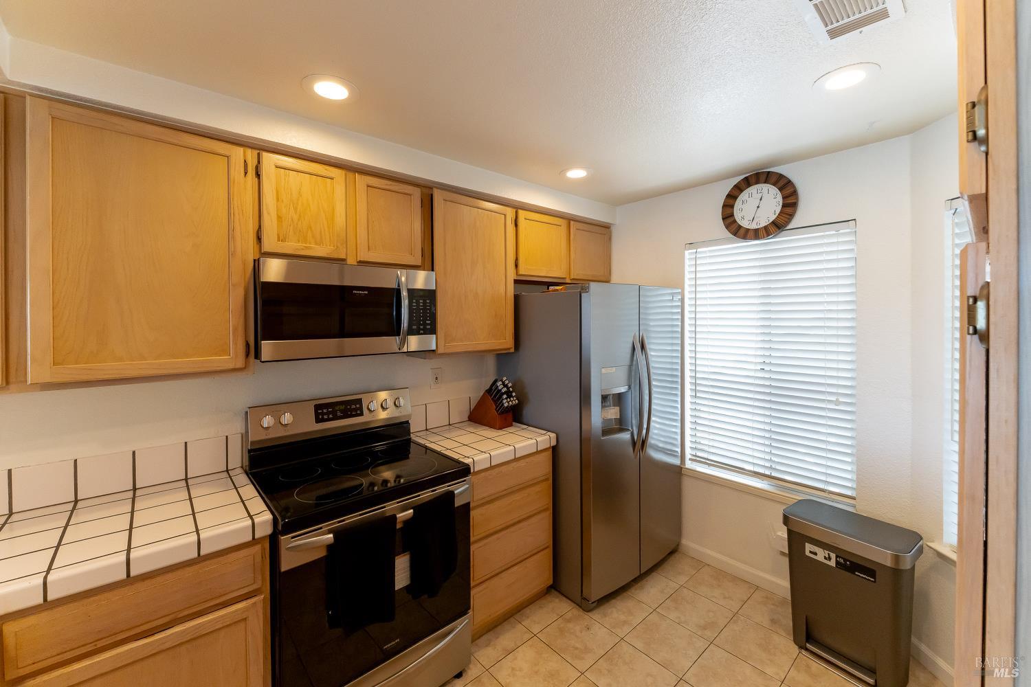 911 Point Reyes Court, Unit 6 Vallejo, CA 94591 - Photo 7 of 35 a kitchen with stainless steel appliances granite countertop a stove a sink dishwasher a refrigerator and a microwave