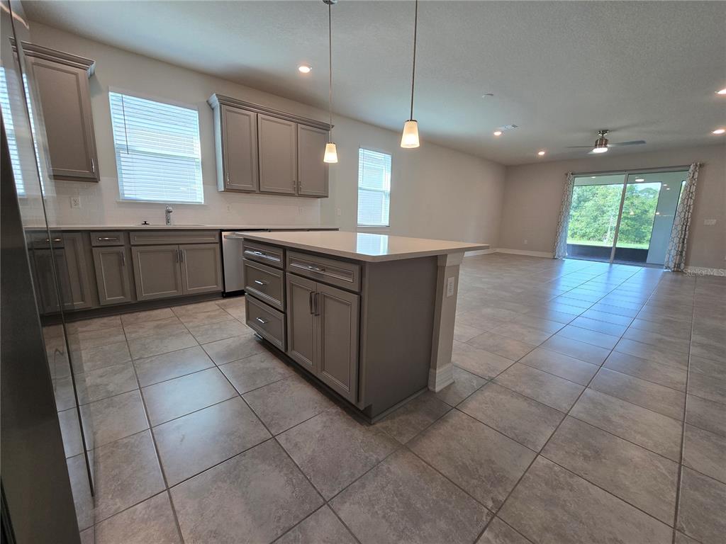 2136 Live Oak Lake Road St. Cloud, FL 34771 - Photo 11 of 42 a kitchen with kitchen island granite countertop a sink a counter top space appliances and cabinets