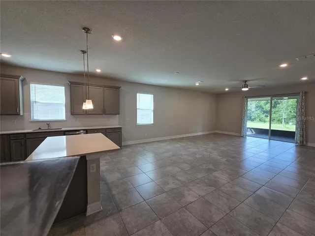 a view of a kitchen with a sink and window