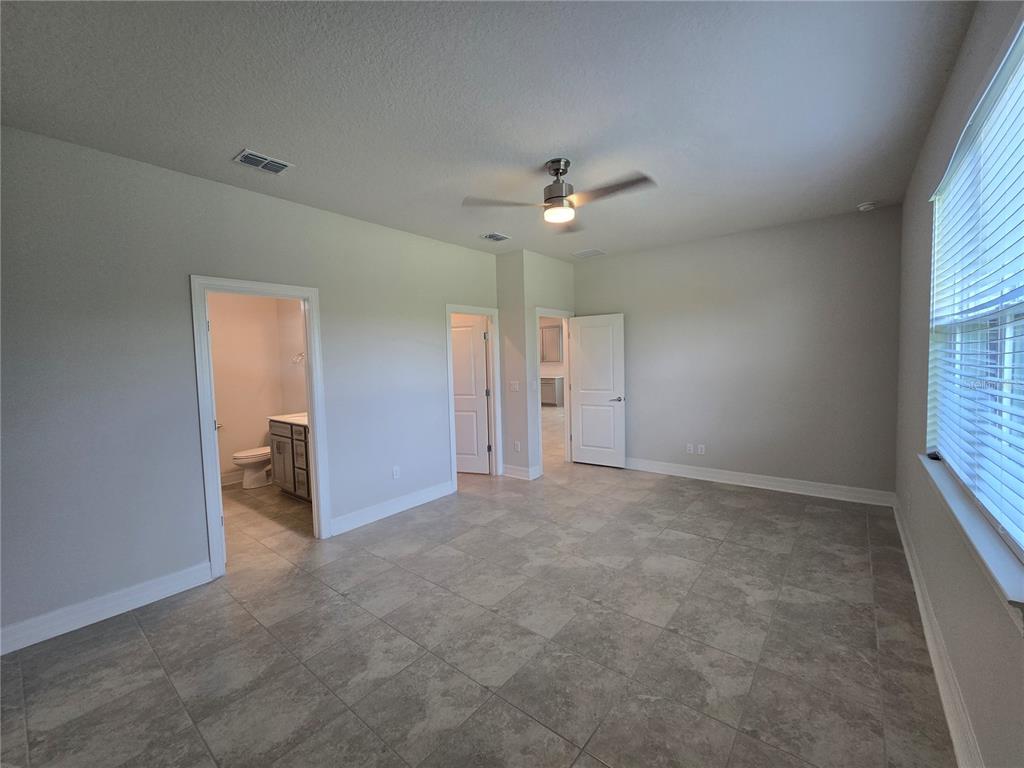 2136 Live Oak Lake Road St. Cloud, FL 34771 - Photo 15 of 42 an empty room with a ceiling fan and a window