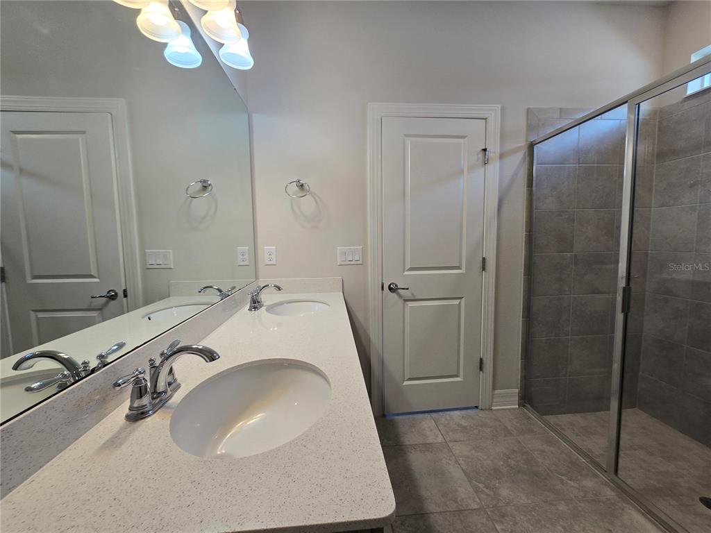 2136 Live Oak Lake Road St. Cloud, FL 34771 - Photo 18 of 42 a bathroom with a sink and a mirror