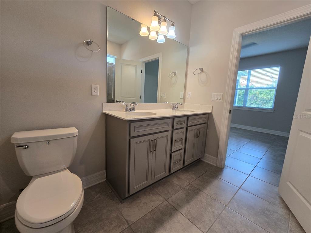 2136 Live Oak Lake Road St. Cloud, FL 34771 - Photo 20 of 42 a view of bathroom with a toilet sink and mirror