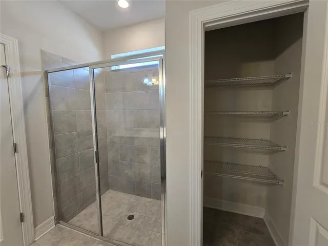a bathroom with a glass shower door