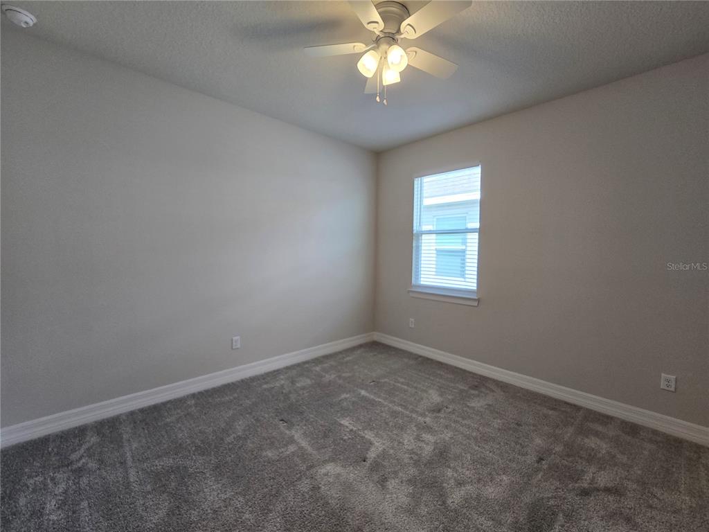 2136 Live Oak Lake Road St. Cloud, FL 34771 - Photo 23 of 42 an empty room with a window and a fan