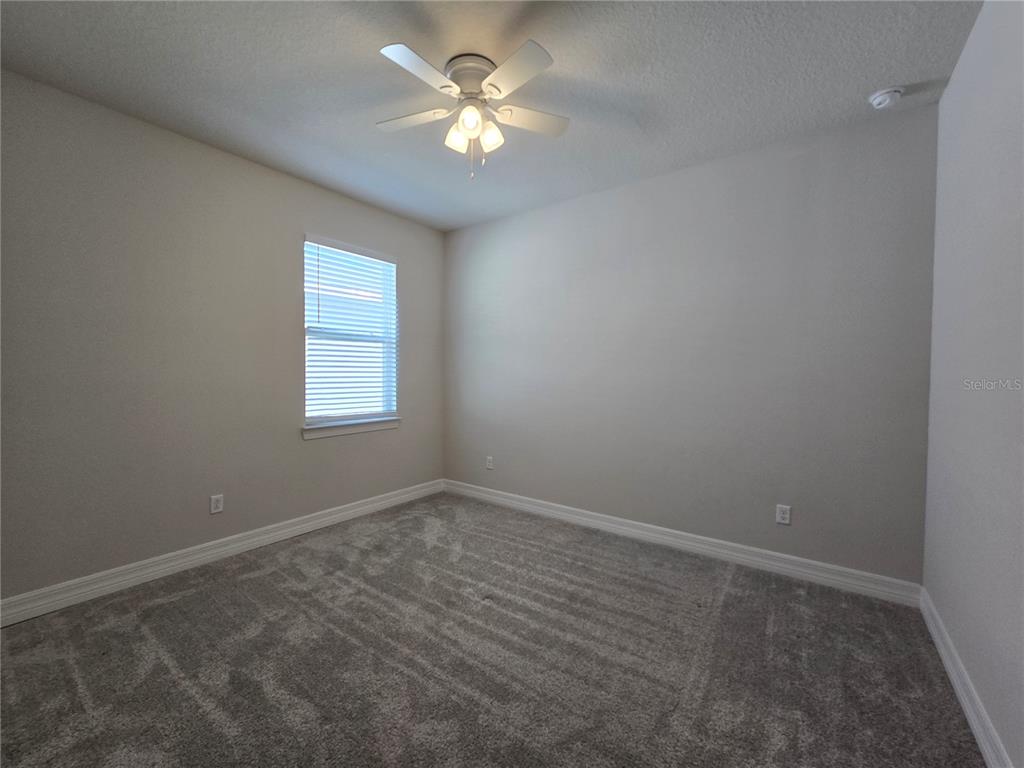 2136 Live Oak Lake Road St. Cloud, FL 34771 - Photo 26 of 42 an empty room with a window and a fan