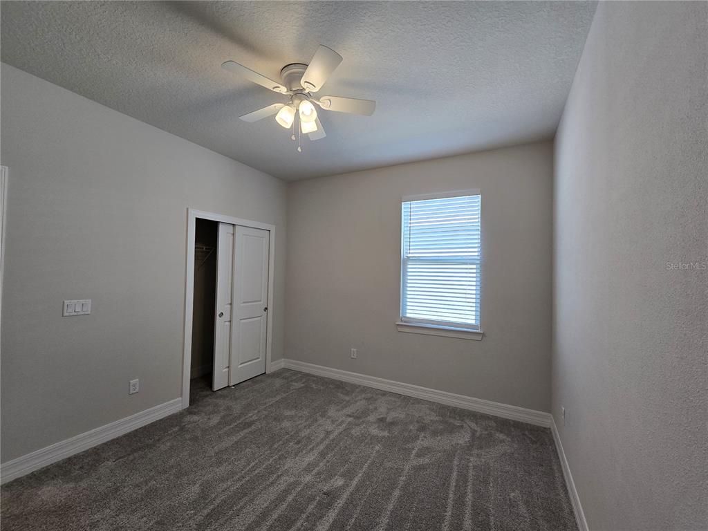 2136 Live Oak Lake Road St. Cloud, FL 34771 - Photo 27 of 42 an empty room with wooden floor and windows