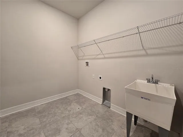 a room with a sink cabinets and wooden floor