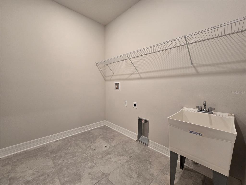 2136 Live Oak Lake Road St. Cloud, FL 34771 - Photo 33 of 42 a room with a sink cabinets and wooden floor