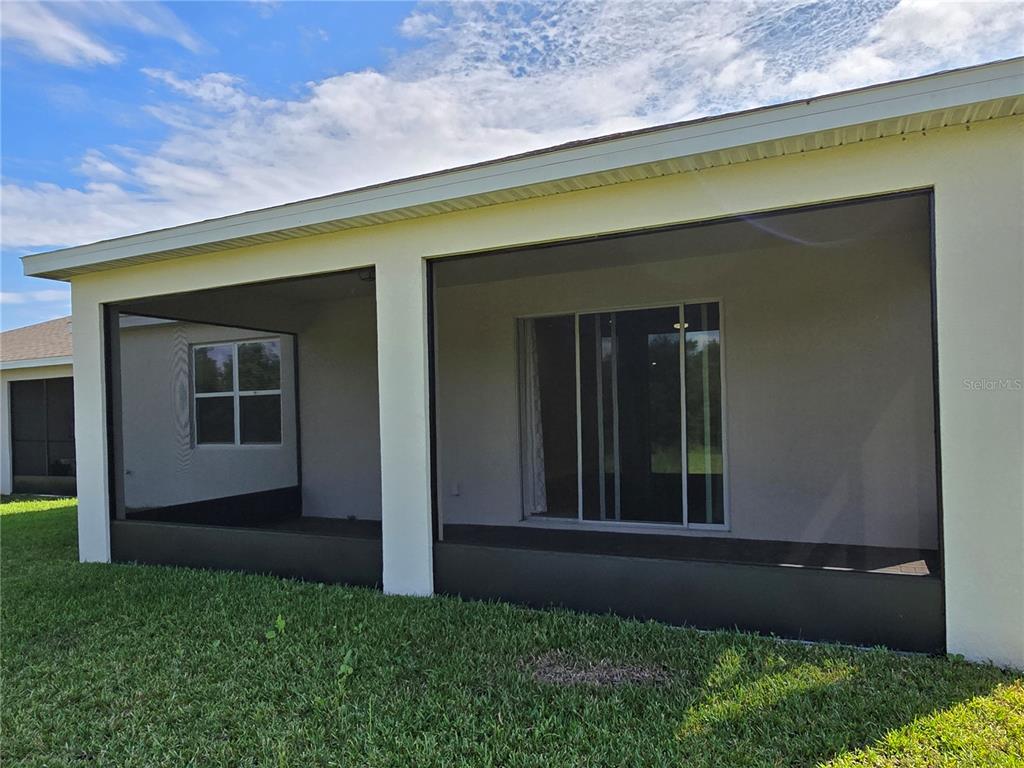 2136 Live Oak Lake Road St. Cloud, FL 34771 - Photo 35 of 42 a backyard of a house with lots of green space