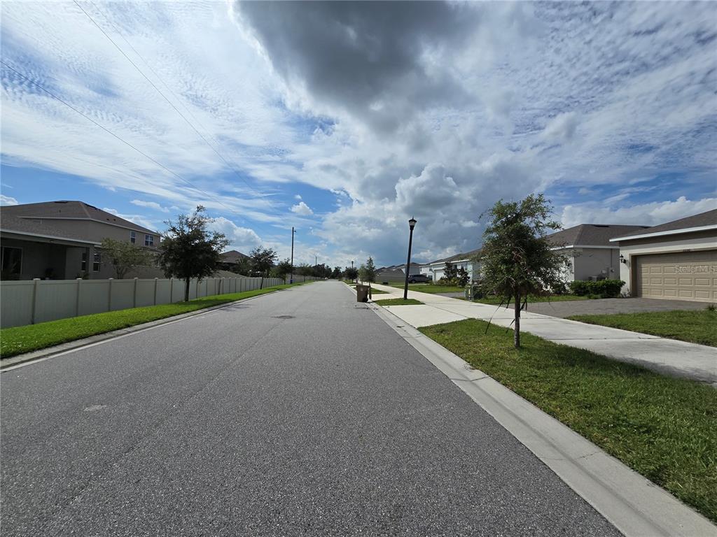 2136 Live Oak Lake Road St. Cloud, FL 34771 - Photo 37 of 42 a view of a street with a yard