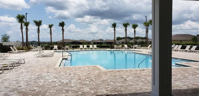 a view of a swimming pool with a lawn chairs