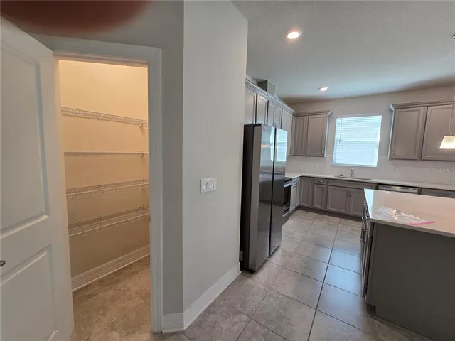 a kitchen with a refrigerator and a sink