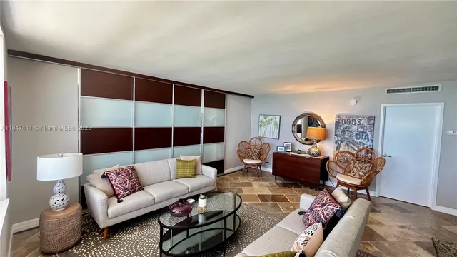 a living room with furniture a rug and a window