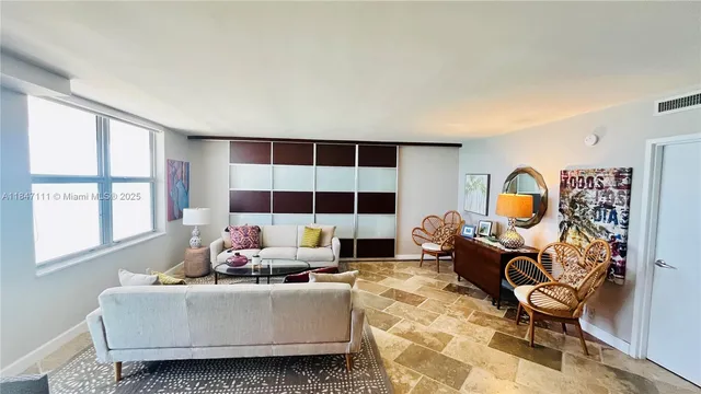 a living room with furniture and a lamp