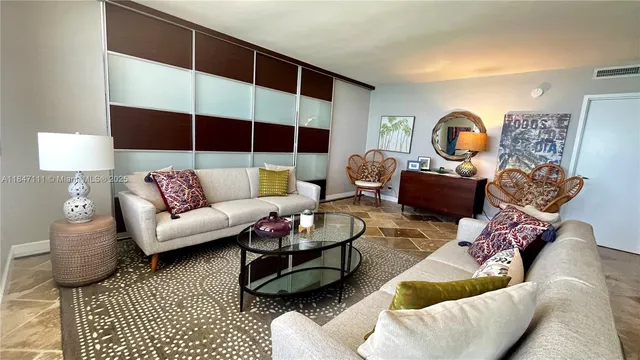 a living room with furniture a rug and a window