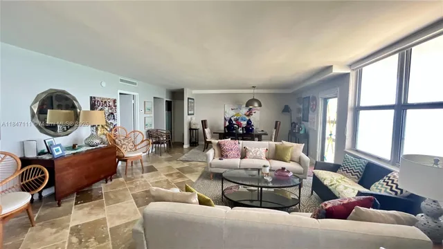 a dining room table with chairs and a rug