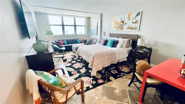 a living room with furniture and two windows
