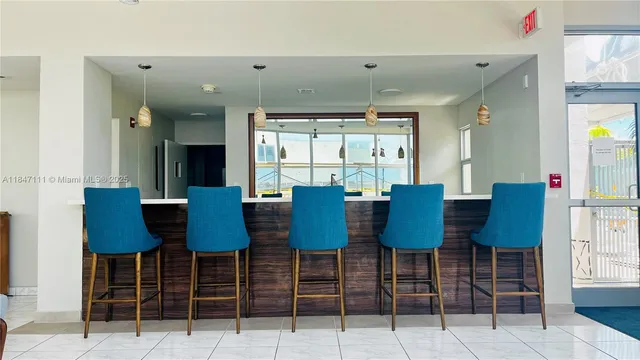 a view of a dining room with furniture and a window