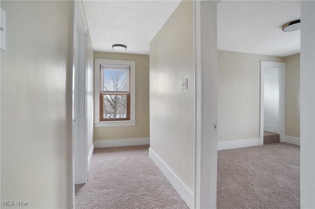 646 Brittain Road Akron, OH 44305 - Photo 28 of 36 Hall with a textured ceiling, carpet, and baseboards