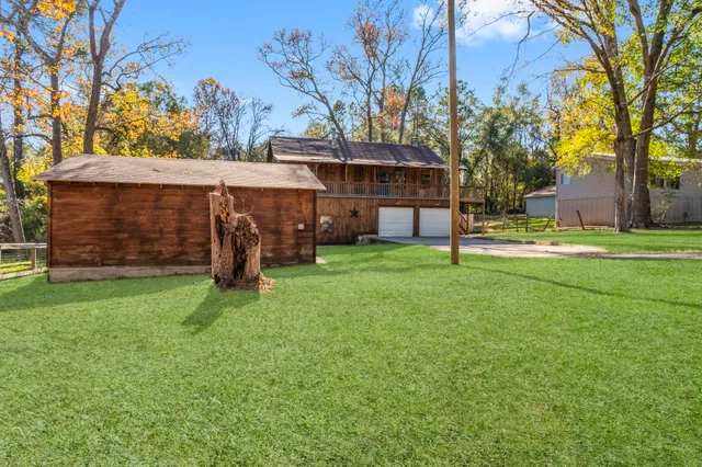 a view of a house with a backyard