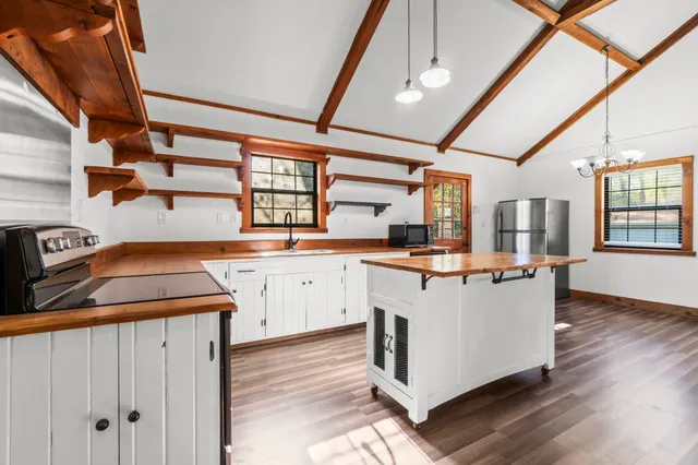 a kitchen with cabinets appliances and a window