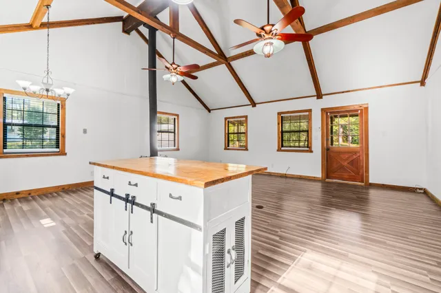 a view of a room with wooden floor and windows