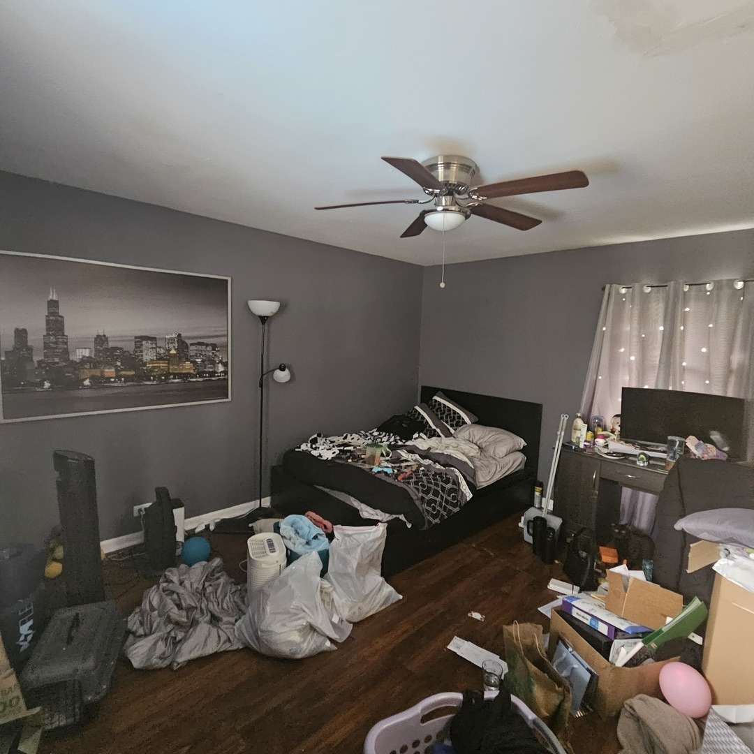 128 Essex Road Elk Grove Village, IL 60007 - Photo 11 of 18 a bed room with furniture and a chandelier