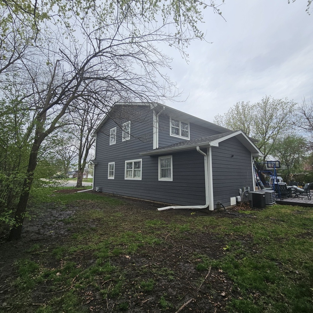 128 Essex Road Elk Grove Village, IL 60007 - Photo 16 of 18 a view of a house with yard and a large tree