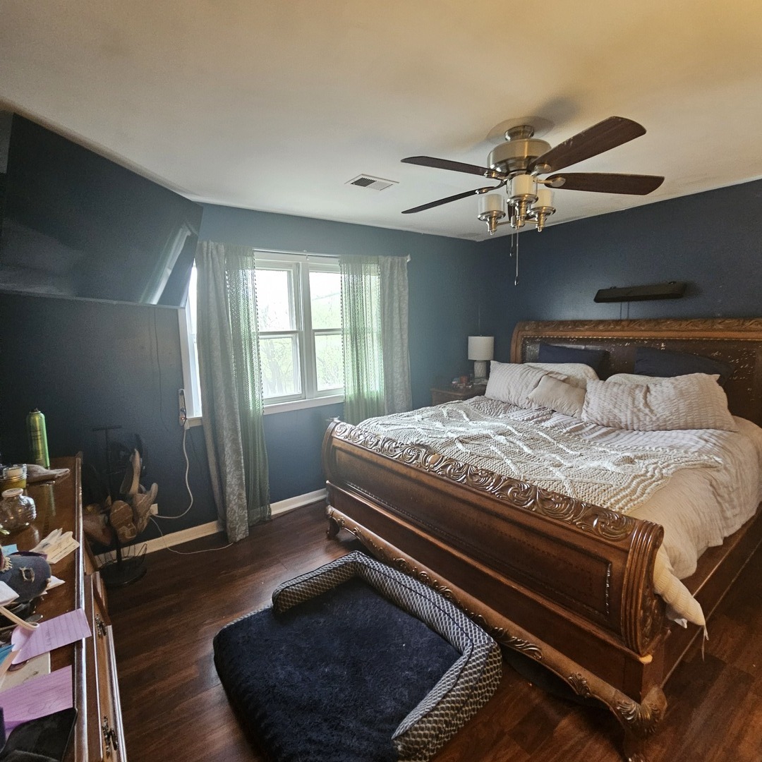 128 Essex Road Elk Grove Village, IL 60007 - Photo 6 of 18 a bedroom with a bed and wooden floor